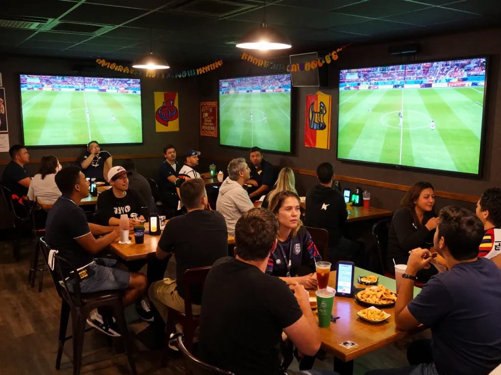 Socolive bóng đá - Fans cheering during a live soccer game with betting options visible, creating an exciting atmosphere.